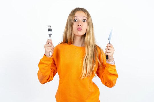 hungry Beautiful teen blonde girl  holding in hand fork knife want tasty yummy pizza pie