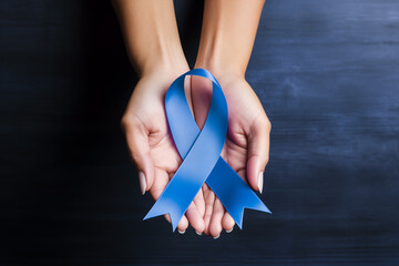 Periwinkle blue ribbon awareness with color bow on woman's hand for stomach and small intestine cancer, esophageal cancer, eating disorder, Irritable Bowel Syndrome awareness 