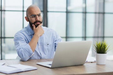 Businessman working on the table with laptop in a new office