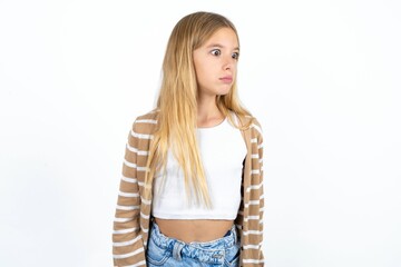 Beautiful teen girl stares aside with wondered expression has speechless expression. Embarrassed...