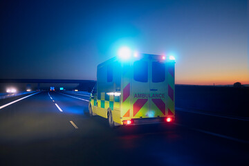 Fast moving ambulance car of emergency medical service on highway at night. Themes healthcare,...