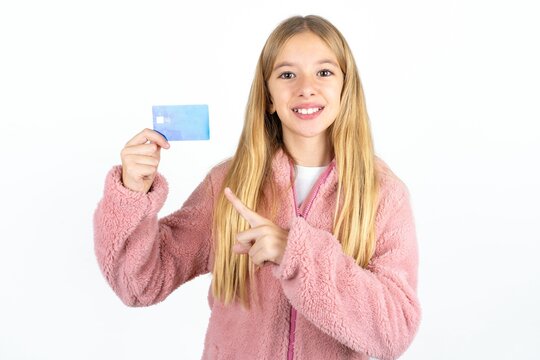 Photo portrait of Beautifu blonde kid girl doing purchase with pointing finger credit bank card
