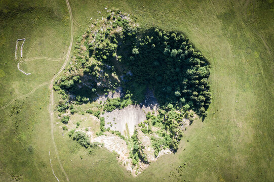 Aerial view of a crater in a field, next to Kupres town in Bosnia and Herzegovina.