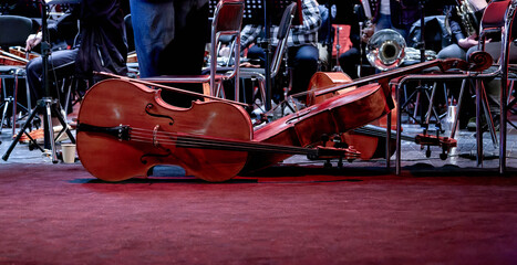  three stringed musical instruments cello lie on the stage