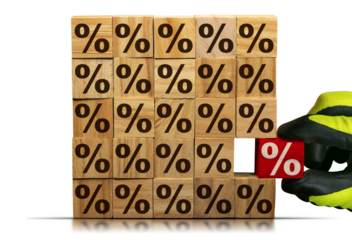 Gloved hand chooses a wooden block with red percentage sign, from a stack of wooden blocks with brown percent signs. Isolated on white or transparent background. Png.