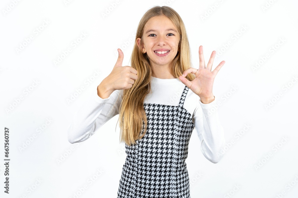 Wall mural beautiful caucasian teen girl smiling and looking happy, carefree and positive, gesturing victory or