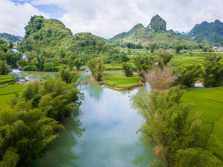 Fototapeta na wymiar Aerial landscape in Quay Son river, Trung Khanh, Cao Bang, Vietnam with nature, green rice fields and rustic indigenous houses