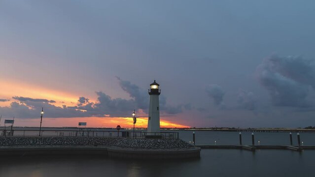 Timelapse of light house at sunset dusk as traffic races behind the Harbor, Rockwall, Texas
