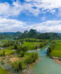 Naklejka na ściany i meble Aerial landscape in Quay Son river, Trung Khanh, Cao Bang, Vietnam with nature, green rice fields and rustic indigenous houses