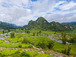 Fototapeta na wymiar Aerial landscape in Quay Son river, Trung Khanh, Cao Bang, Vietnam with nature, green rice fields and rustic indigenous houses