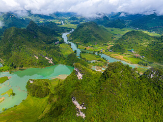 Aerial landscape in Quay Son river, Trung Khanh, Cao Bang, Vietnam with nature, green rice fields and rustic indigenous houses