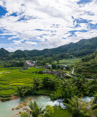 Aerial landscape in Quay Son river, Trung Khanh, Cao Bang, Vietnam with nature, green rice fields and rustic indigenous houses