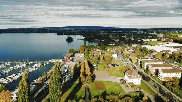Panoramic aerial view of Swiss lakeside city near vast alpine lake featuring the Lake of Zug and alpine scenery in the alps of Switzerland  