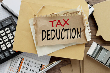 paper out of a laptop screen, isolated on pink background Tax Deduction