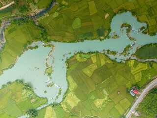 Fototapeta premium Aerial view of dawn on mountain at Ngoc Con ward, Trung Khanh town, Cao Bang province, Vietnam with river, nature, green rice fields. Near Ban Gioc waterfall.