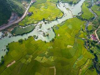 Aerial view of dawn on mountain at Ngoc Con ward, Trung Khanh town, Cao Bang province, Vietnam with river, nature, green rice fields. Near Ban Gioc waterfall.