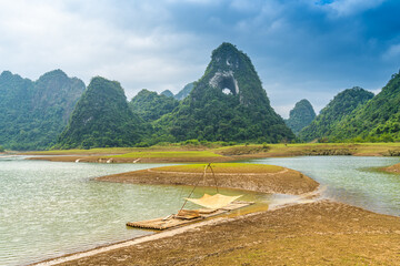 Aerial view of Thung mountain in Tra Linh, Cao Bang province, Vietnam with lake, cloudy, nature. - Powered by Adobe