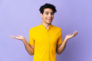 Young Venezuelan man isolated on purple background with shocked facial expression
