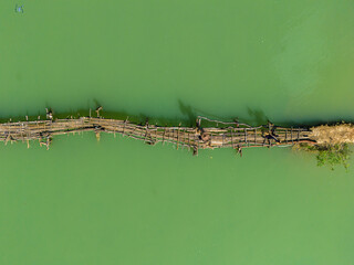 Aerial landscape in Phong Nam valley, farmers carry rice home at Cao Bang province, Vietnam with river, nature, green rice fields