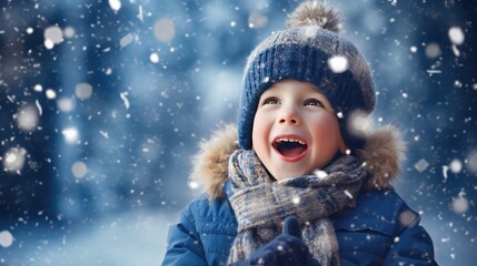 a funny little boy in blue winter clothes playfully catching snowflakes with his tongue during a snowfall. Ideal for promoting the joy of winter activities for kids