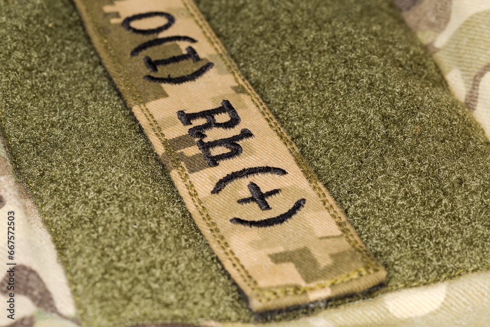 Poster Military blood type sticker on a camouflage uniform