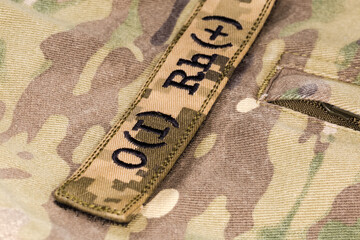 Military blood type sticker on a camouflage uniform