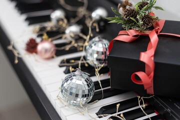 Piano keyboard with Christmas decoration, closeup.