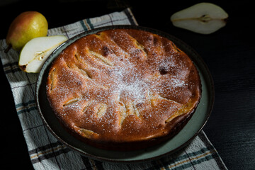 pear pie rustic with fresh fruits on dark background