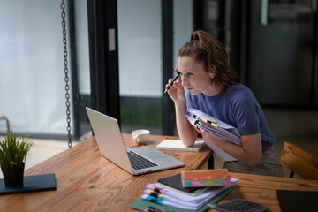 Businesswoman working hard with a lot of documents, searching and checking information