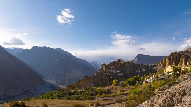 4K Time lapse shot of the clouds above Dhankar Monastery during sunset at Spiti Valley in Himachal Pradesh, India. Shadow of nearby mountain covers the entire monastery as sun sets. Natural background