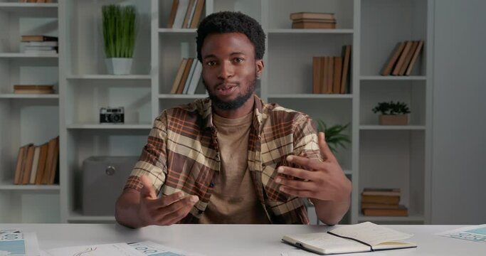 African American having interview, talking about himself, looking at camera.