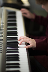 Fototapeta premium Hands on piano keyboard