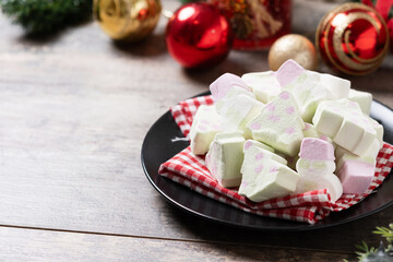 Christmas marshmallow and Christmas decoration on wooden table. Copy space
