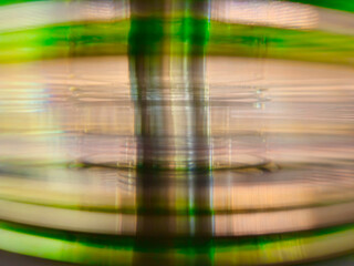 Close-up to interesting abstract patterns created by the rays of sunlight penetrating through a pile of CD arranged on the desk, Lodz, Poland.