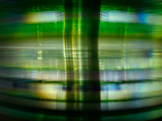 Close-up to interesting abstract patterns created by the rays of sunlight penetrating through a pile of CD arranged on the desk, Lodz, Poland.
