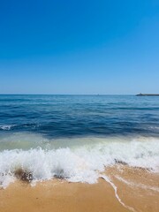Blue sea horizon, waves seascape, blue clear sky, sandy coast