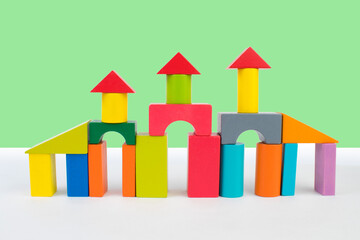 Palace from blocks of children's constructor on a green background. For the development of the child.