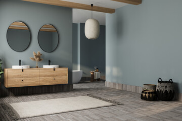Elegant bathroom with blue tones walls, white basin with oval mirrors, bathtub, shower, plants, and tiled floor. Boho scandinavian bathroom. - obrazy, fototapety, plakaty