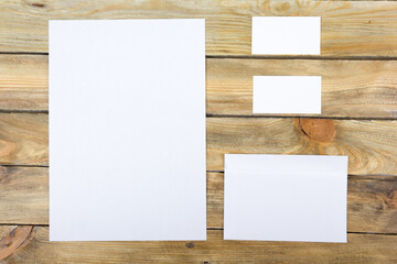 Business card. Corporate stationery set mockup. Blank textured brand ID elements on wooden table. Top view. Office desk tabl.