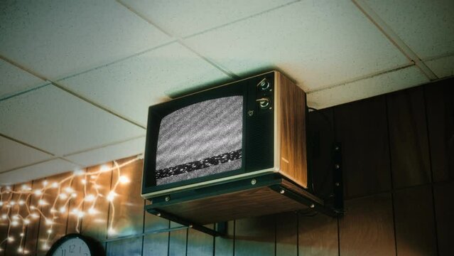 Old TV Static Noise Screen Attached Wall Low Angle View Television, Zoom In. Retro Television With Static Noise Screen Attached To A Wall, Low Angle View. Zoom In