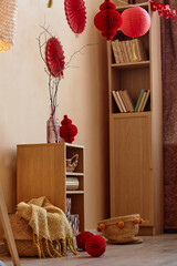 Vertical background image of cozy home interior with red paper lanterns and decorations for Chinese New Year