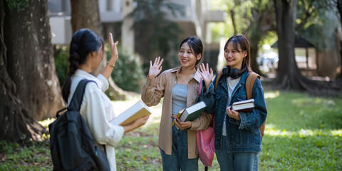 Happy young student chat with each other after class. Guy and girls wear casual clothes to study. Lifestyle College and University life concept, sincere emotions