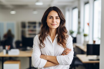 Obraz premium Happy casual businesswoman looking at camera with crossed arms in office, New generation of energetic entrepreneurs concept.