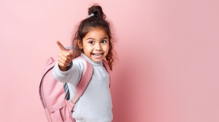 Cheerful School Girl Gesturing Thumbs-Up Smiling To Camera Posing Over Studio Background. I Like School Concept.