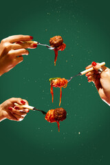 Female hands holding forks with spaghetti and meatball over green background. Tomato sauce and basil. Concept of Italian food, cuisine, taste, cooking, menu. Pop art. Poster, ad