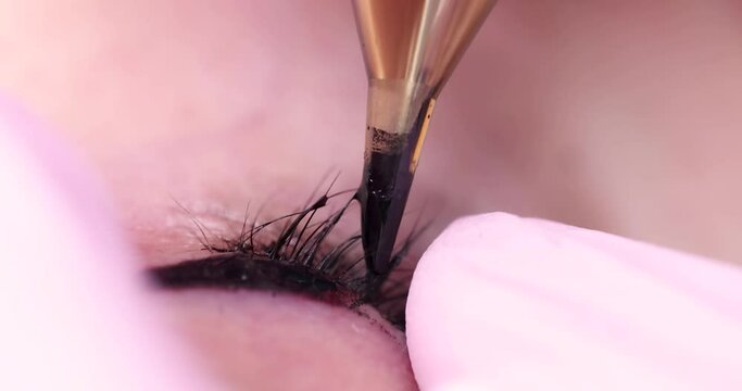 Permanent makeup artist applying black arrows to client 4k movie. Beauty industry concept