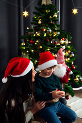 Mother with her son near the Christmas tree