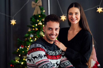 Portrait of happy young couple at christmas time at home