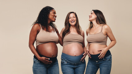 Belly bumps: Multicultural friends embrace their pregnancy journeys - obrazy, fototapety, plakaty