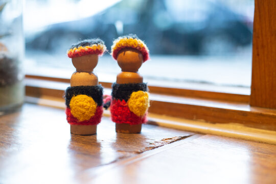 Crocheted craft dolls in Aboriginal flag colours